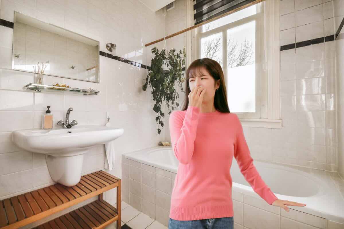 bagno e donna che si tappa naso